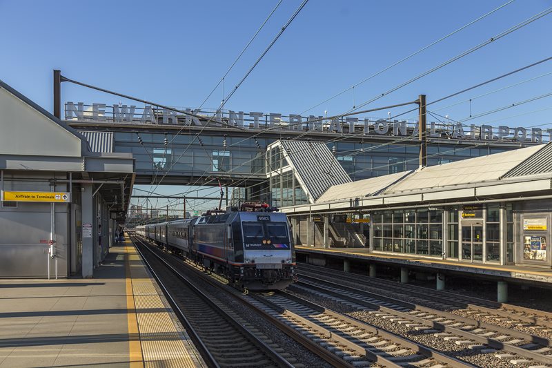 NJ Transit train sits on track below pedestrian overpass at Newark Liberty International Airport Train Station