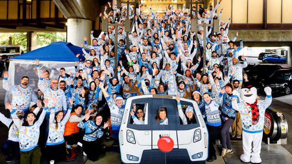 Large group with BART sweaters pose on stairs